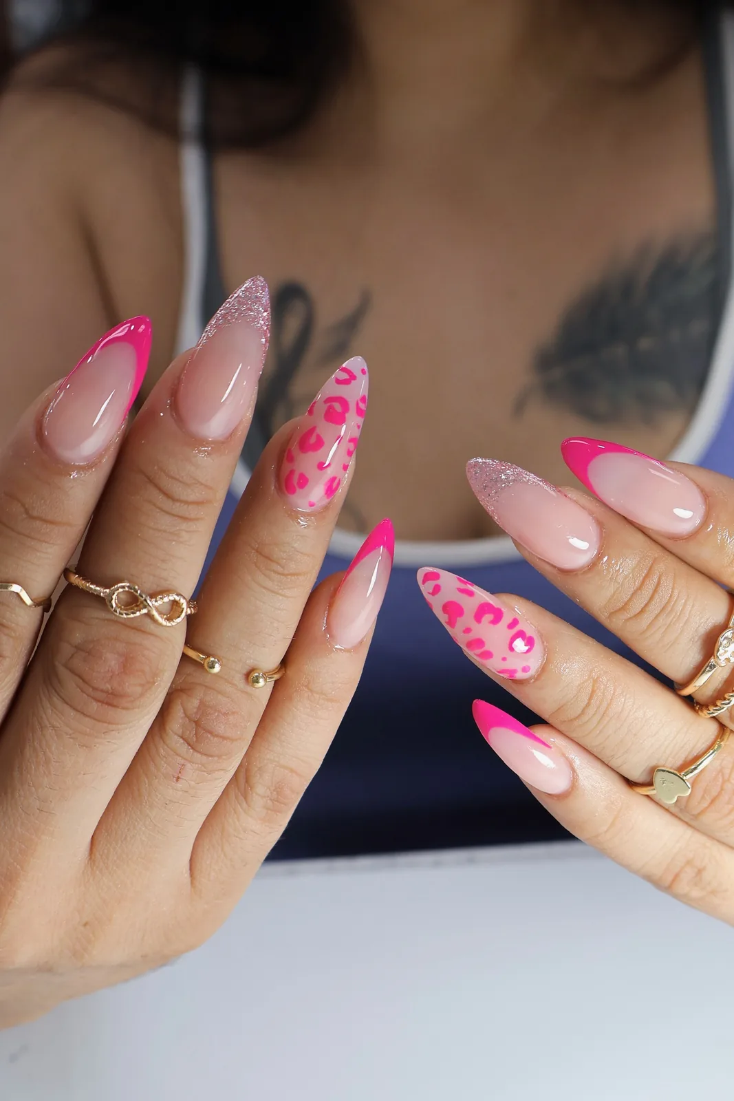 Hot-pink French and leopard print almond nails with glitter accents