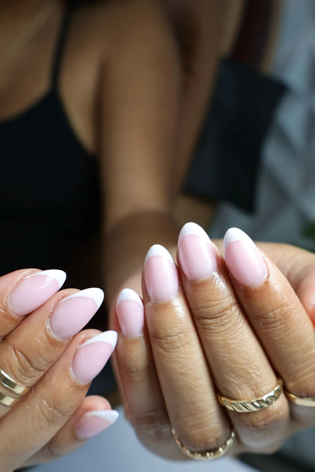Soft pink and white French almond nails with a glossy finish